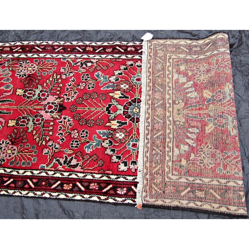 2519 - A Malayer runner with overall floral pattern on a red ground, 400 x 83cm