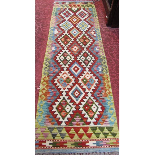 2530 - A Choi kilim runner with a stepped interlocking lozenge design. 196cm x 61cm.