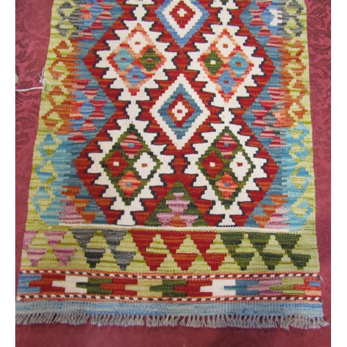 2530 - A Choi kilim runner with a stepped interlocking lozenge design. 196cm x 61cm.