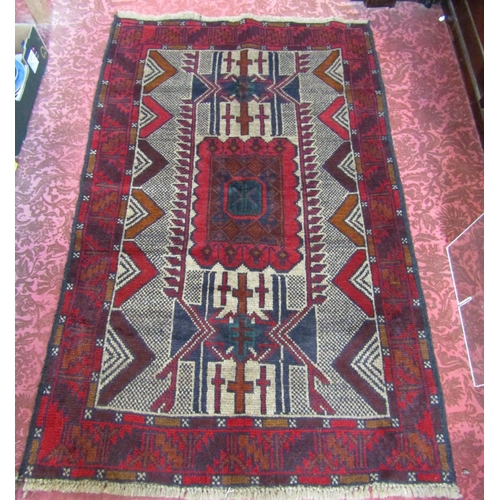 2533 - An old Baluchi rug with a central rectangular shaped medallion. 130cm x 85cm approx