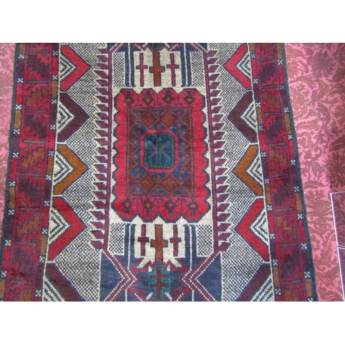 2533 - An old Baluchi rug with a central rectangular shaped medallion. 130cm x 85cm approx