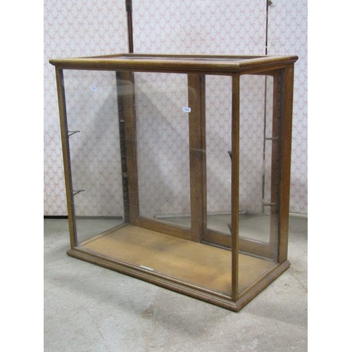 2134a - A oak framed counter top display cabinet of rectangular form enclosed by a pair of sliding doors lab... 