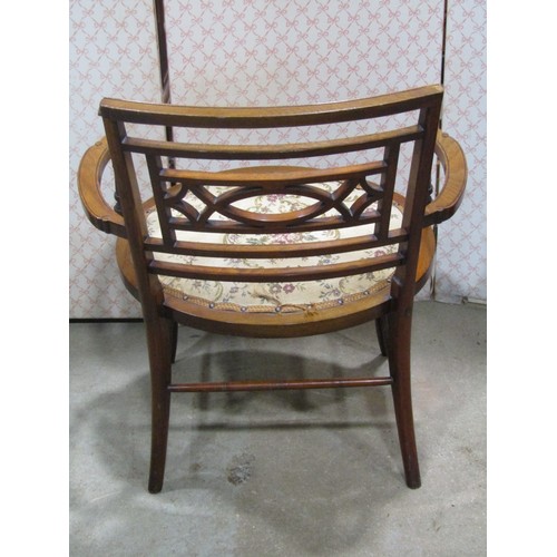 2243a - A late Victorian\Edwardian low open armchair with moulded frame and oval upholstered pad seat raised... 