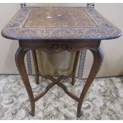 2138 - An Edwardian oak occasional table, the overhanging square top with rounded corners and carved repeat... 