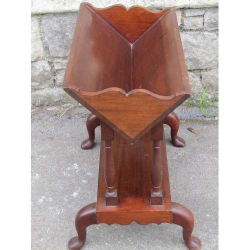 2369a - A Georgian style mahogany two tier book trough/stand with shaped outline and supports