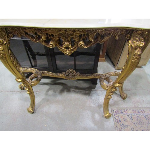 2166 - A reproduction console/pier table raised on four shaped and scrolled gilt supports, with acanthus an... 