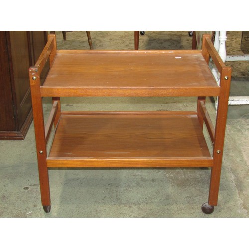 2209 - A 1960s teakwood tea trolley on two tiers with chrome fittings together with one other (2)