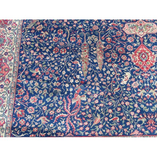 2460 - A large country house size carpet with 3 central medallions on a blue busy floral and bird pattern g... 