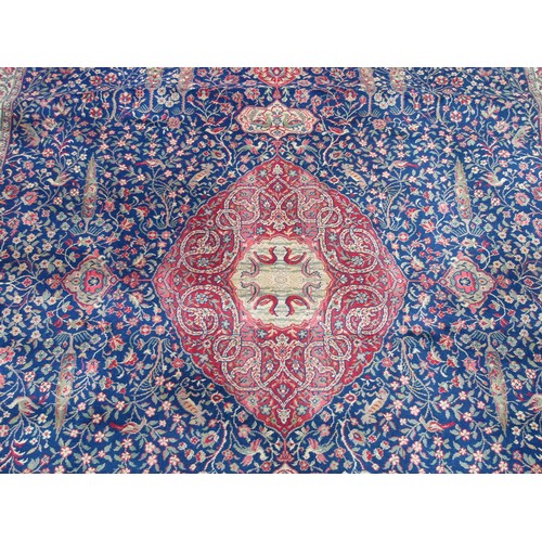 2460 - A large country house size carpet with 3 central medallions on a blue busy floral and bird pattern g... 