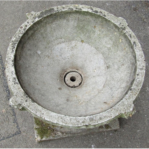 2004 - A weathered cast composition stone two sectional garden urn, the squat circular bowl with repeating ... 