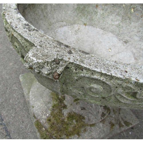 2004 - A weathered cast composition stone two sectional garden urn, the squat circular bowl with repeating ... 
