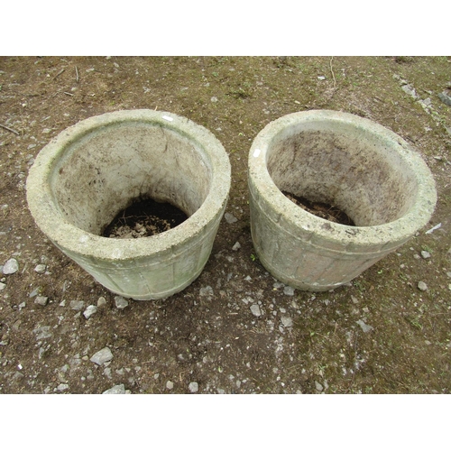 2017 - A pair of weathered cast composition stone garden planters in the form of coopered half barrels, 40c... 