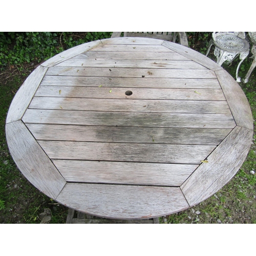 2020 - A weathered hardwood folding circular garden table with slatted top 125 cm diameter, retailed by Joh... 