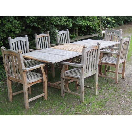2031 - A good quality weathered hardwood  extending garden table of rectangular form with slatted top and b... 