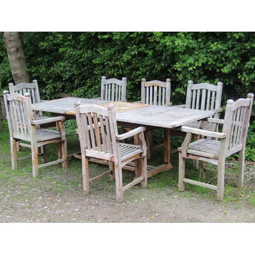 2031 - A good quality weathered hardwood  extending garden table of rectangular form with slatted top and b... 