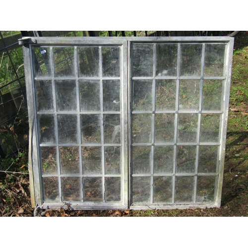 2034 - Four reclaimed heavy gauge galvanised steel framed windows with leaded light panels, the largest 100... 