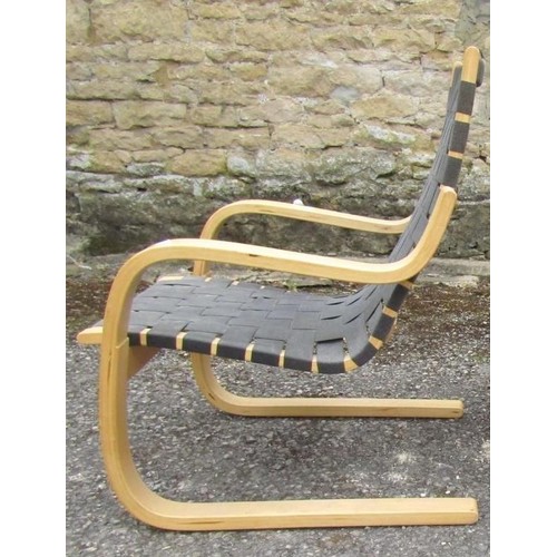 276 - ALVAR AALTO FOR ARTEK: A ‘406’ ARMCHAIR, beech framed with black webbing cushion and seat, foil labe... 