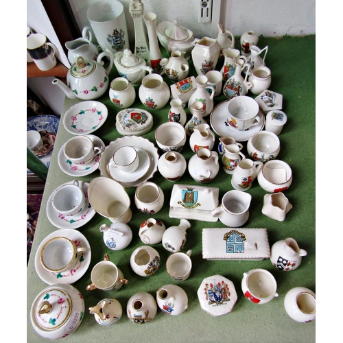 107 - A large collection of crested ware to include Goss and Grafton armorial miniature ceramics, together... 