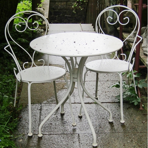 1079 - A cream painted light steel three piece garden terrace/bistro set comprising circular top table toge... 