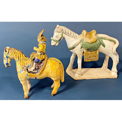 103 - A Chinese terracotta horse with painted detail and a further ceramic horse and rider