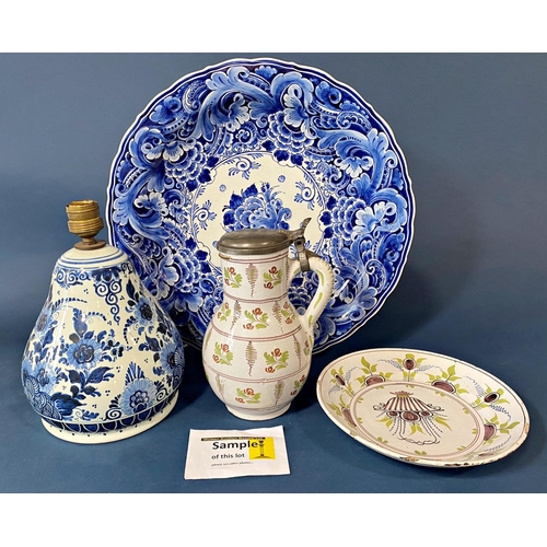 122 - A late 19th century later Delftware comprising dishes, vase and cover, lidded pot, open plates, etc,... 