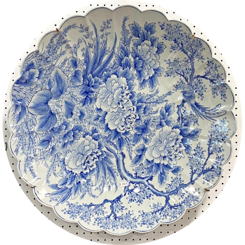 66 - Large Japanese blue and white lobed porcelain dish, decorated with flowers, birds and trees, blue se... 