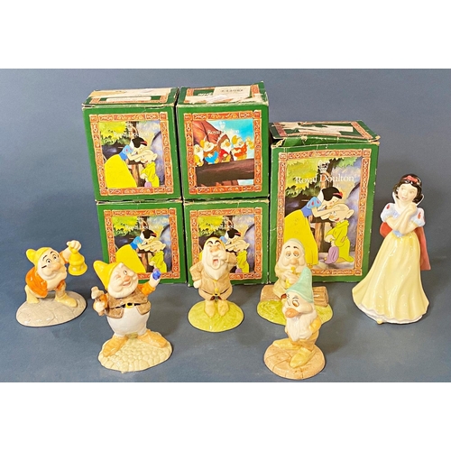 74 - A collection of boxed Royal Doulton Snow White and Dwarfs set including Snow White, Bashful, Grumpy,... 