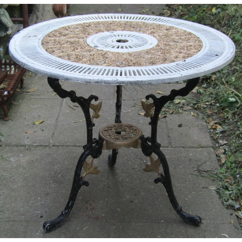 1078 - A painted cast aluminium garden terrace table with decorative circular pierced top raised on swept a... 