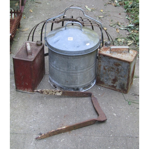 1087 - A vintage galvanised cylindrical bin with domed lid and loose loop handle together with a vintage ir... 