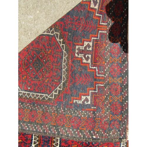 A Bokhara rug with two rows of elephant foot gul, 170cm x 87cm