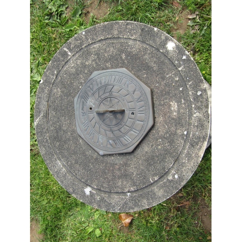 1058 - A weathered contemporary sundial of octagonal form with pierced gnomon sat on a weathered cast compo... 