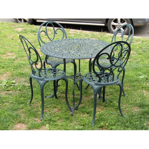 1065 - A contemporary green painted cast aluminium five piece garden terrace set comprising circular topped... 