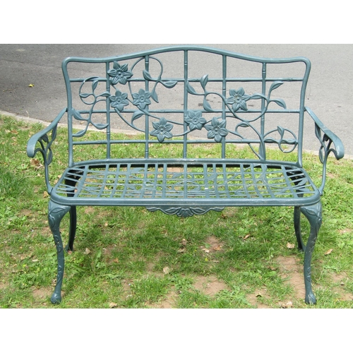 1066 - A contemporary green painted cast aluminium two seat garden bench with decorative pierced trailing f... 