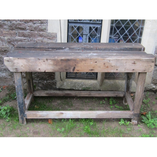 1068 - Two vintage pine work benches of varying size, one incorporating a frieze drawer, the larger example... 