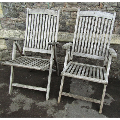 1076 - A pair of weathered hardwood folding garden armchairs with slatted seats and backs, labelled Beaufor... 