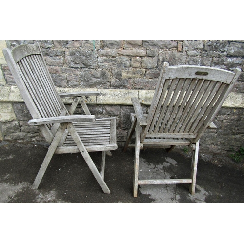 1076 - A pair of weathered hardwood folding garden armchairs with slatted seats and backs, labelled Beaufor... 