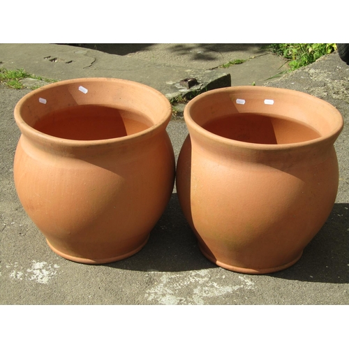 1081 - A pair of contemporary terracotta oviform garden planters 40 cm in diameter, approx same in height