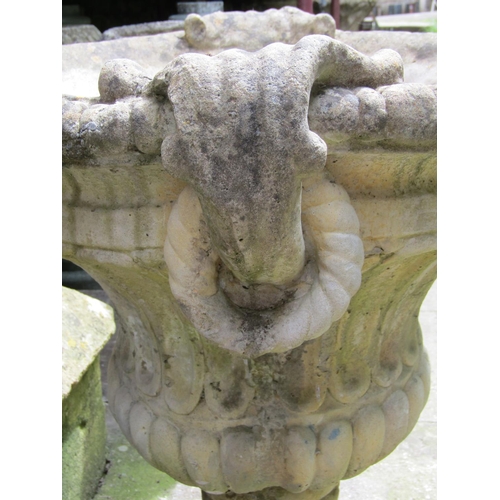 1084 - A weathered cast composition stone garden urn with circular lobed and fluted body, flared gadrooned ... 