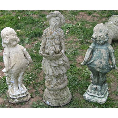 1089 - Two cast composition stone garden ornaments in the form of girls in standing pose clutching the hem ... 