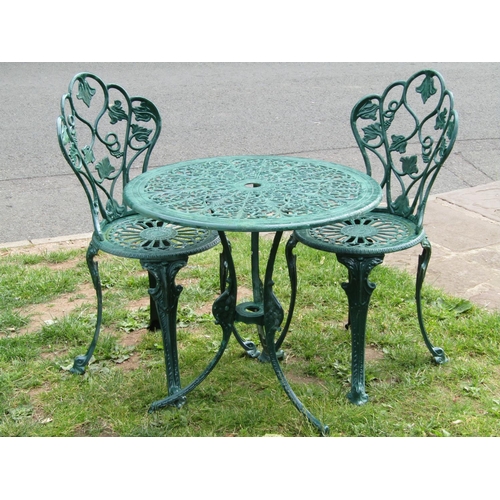 1092 - A green painted cast aluminium garden terrace table of circular form with decorative pierced top rai... 