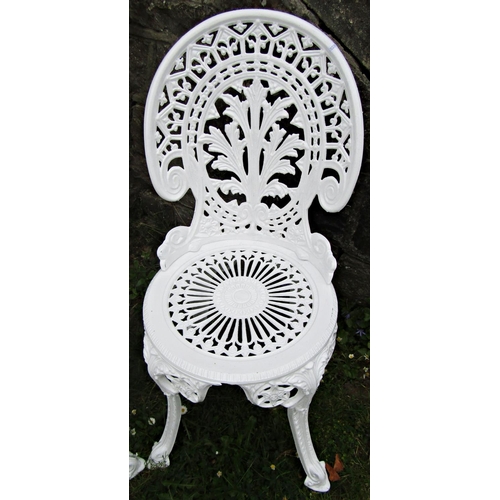 1094 - A pair of white painted cast aluminium garden chairs with decorative pierced geometric and floral de... 