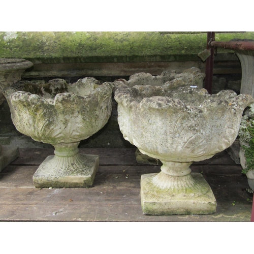 1102 - Three matching weathered cast composition stone garden urns with circular acanthus leaf bowls raised... 