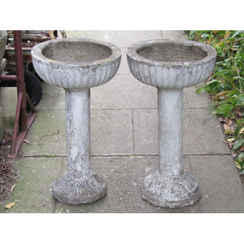 1105 - A pair of painted and weathered cast composition stone garden planters with circular fluted bowls ra... 