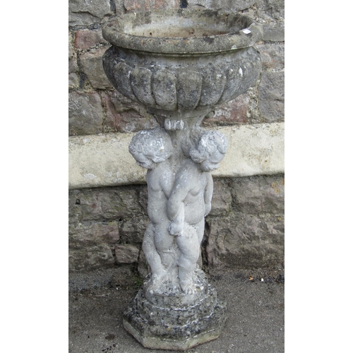 1109 - A weathered cast composition stone garden planter, the circular lobed bowl raised on a pedestal in t... 