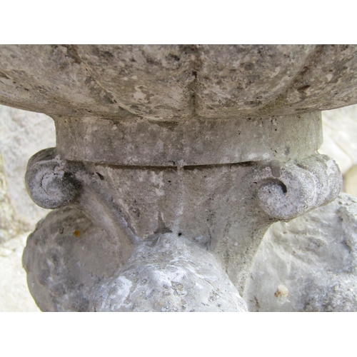 1109 - A weathered cast composition stone garden planter, the circular lobed bowl raised on a pedestal in t... 