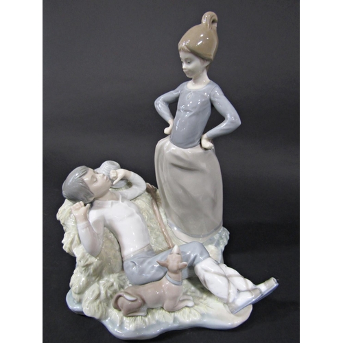 131B - A Lladro figure group of a girl waking a boy harvester with printed mark to base, 25cm tall approx