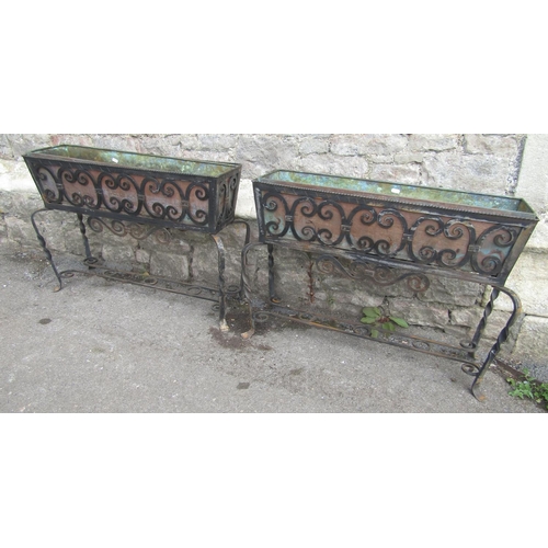 1123 - A pair of good quality decorative iron work freestanding planters of rectangular form with decorativ... 