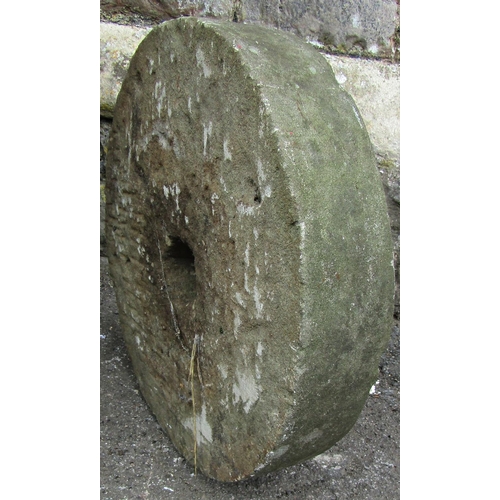 1152 - A small weathered natural stone millstone 45 cm in diameter x 10 cm