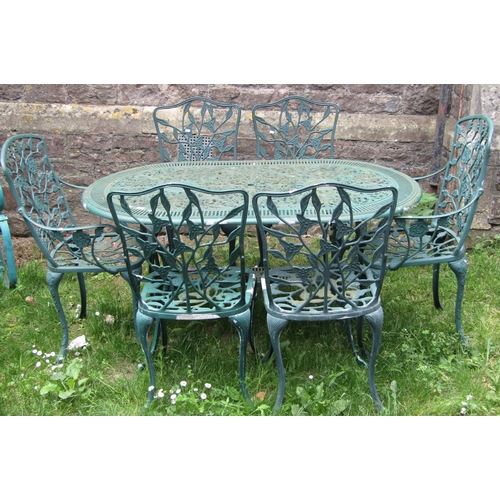 1062 - A contemporary green painted cast aluminium garden terrace table of oval form with decorative pierce... 