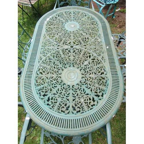 1062 - A contemporary green painted cast aluminium garden terrace table of oval form with decorative pierce... 